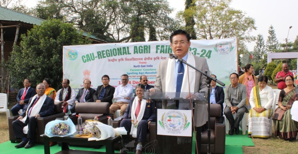 Advisor Mhathung Yanthan addressing the CAU Regional Agri Fair 2023-24 Input Distribution programme at Expositional Hall, State Agri Expo, 4th Mile, Chümoukedima on December 14. (DIPR Photo)
